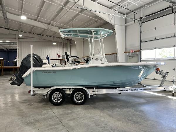 Tidewater 210 LXF 2024 Tidewater 210 LXF boat on a trailer in a spacious indoor facility.