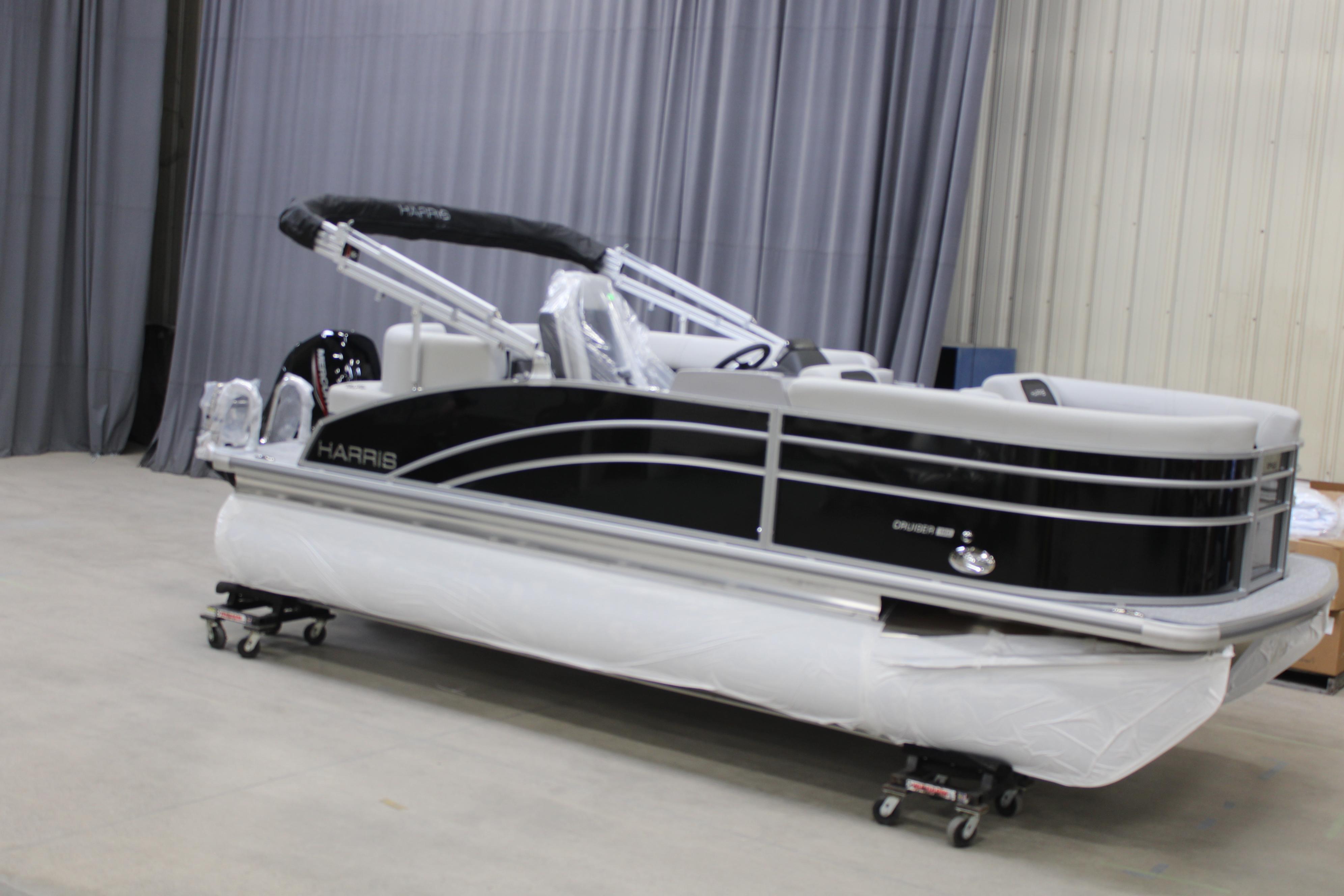 Harris Cruiser 190 2025 Harris Cruiser 190 pontoon boat in a showroom, wrapped for protection.