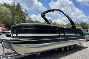 Bennington RFBASR 2024 Bennington RFBASR pontoon boat on trailer under a cloudy sky.