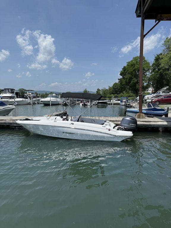 Stingray 182SC 2025 Stingray 182SC boat docked at a marina on a sunny day.