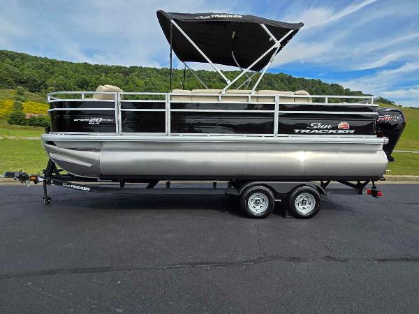 Sun Tracker SportFish 20 DLX 2025 Sun Tracker SportFish 20 DLX pontoon boat on trailer, scenic background.