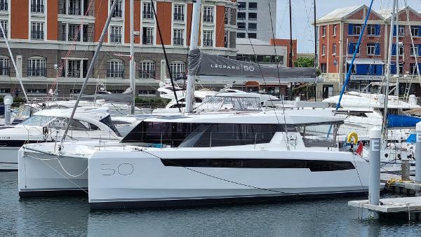 Leopard 50 2022 Leopard 50 catamaran docked in a marina, surrounded by other boats.