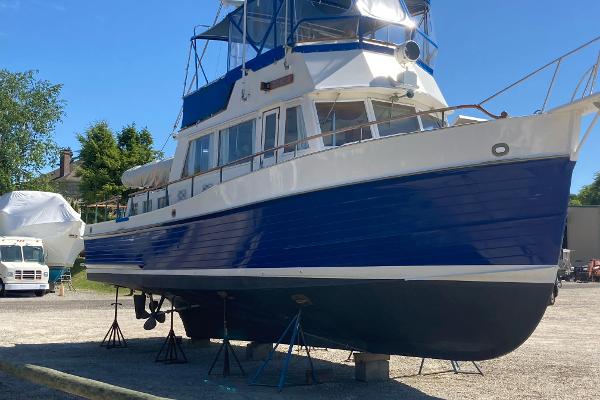 Grand Banks 42 Classic 1983 Grand Banks 42 Classic boat on stands, blue and white hull, outdoor setting.