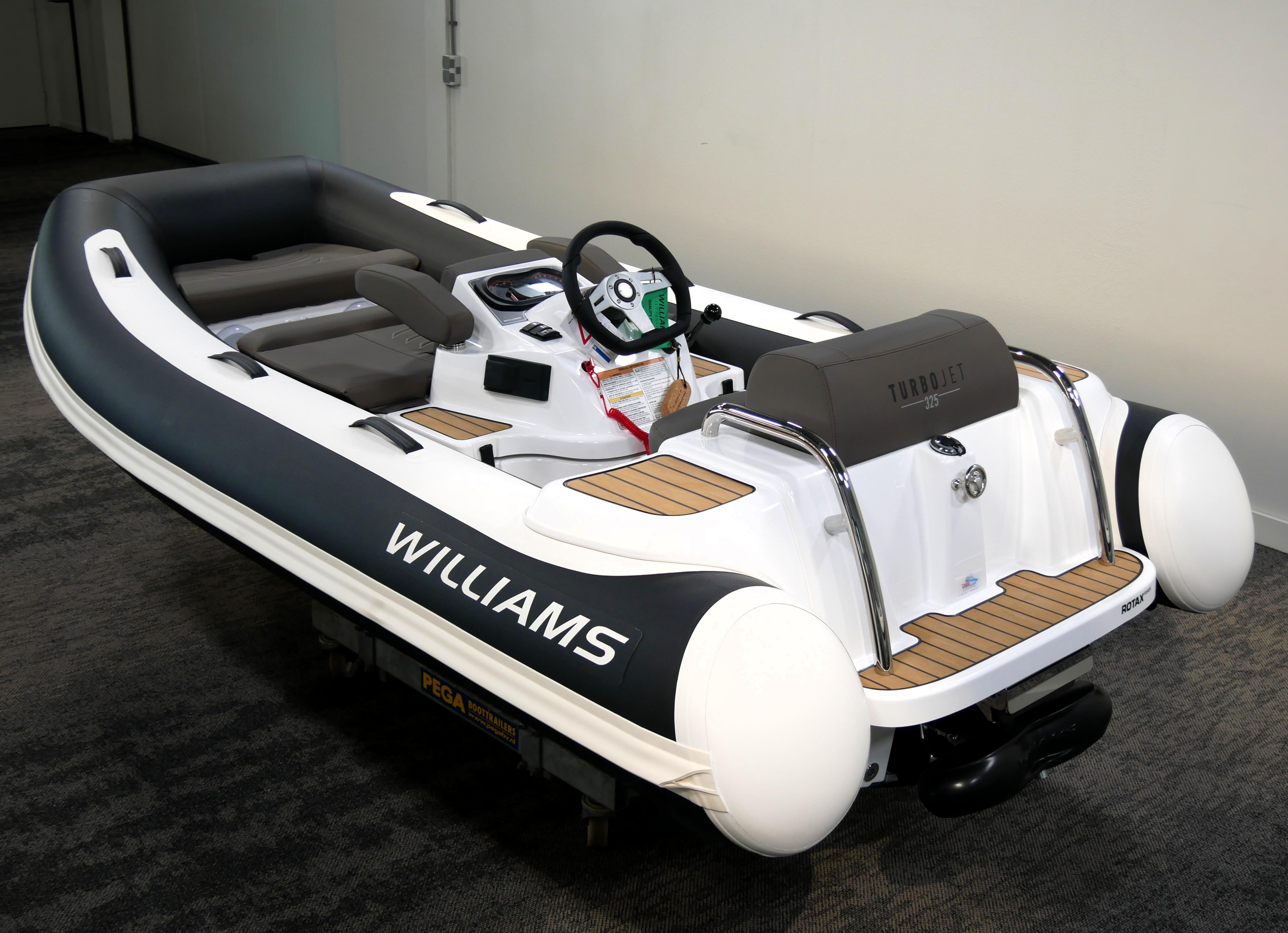 Williams Jet Tenders Turbojet 325 2025 Williams Jet Tenders Turbojet 325, sleek design, white and black color scheme, indoor display.