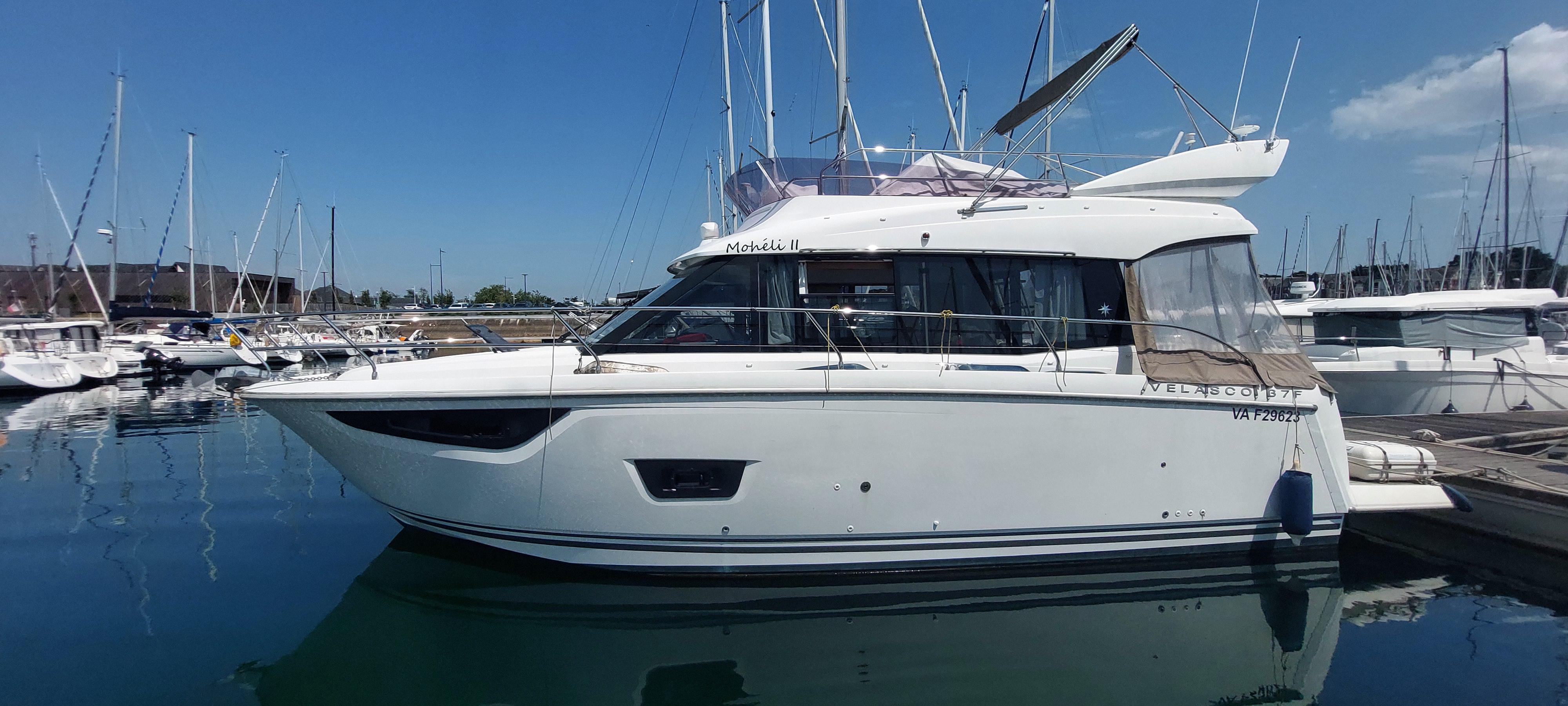 Jeanneau Velasco 37F 2015 Jeanneau Velasco 37F yacht docked in a marina under clear skies.