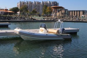 Zodiac Medline 550 NEO 2011 Zodiac Medline 550 NEO boat docked in a marina with urban buildings in the background.