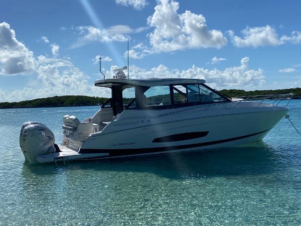 Regal 36 XO 2023 Regal 36 XO boat anchored in clear blue water under a sunny sky.