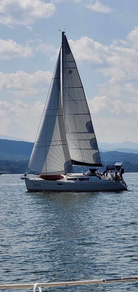 Jeanneau Sun Odyssey 36i 2008 Jeanneau Sun Odyssey 36i sailboat on calm water under a partly cloudy sky.
