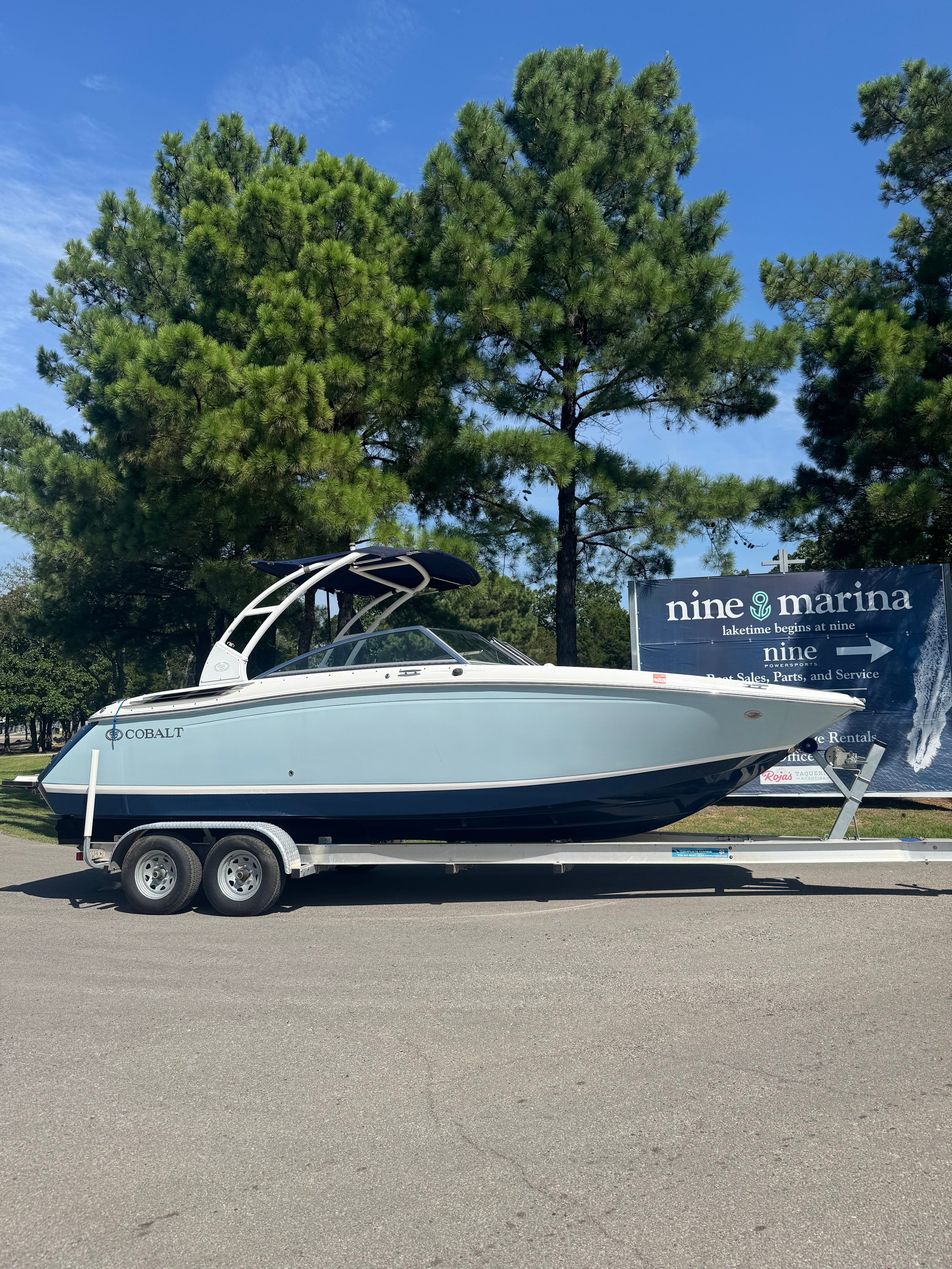 Cobalt 26 SD 2015 Cobalt 26 SD boat on trailer at marina, surrounded by trees.