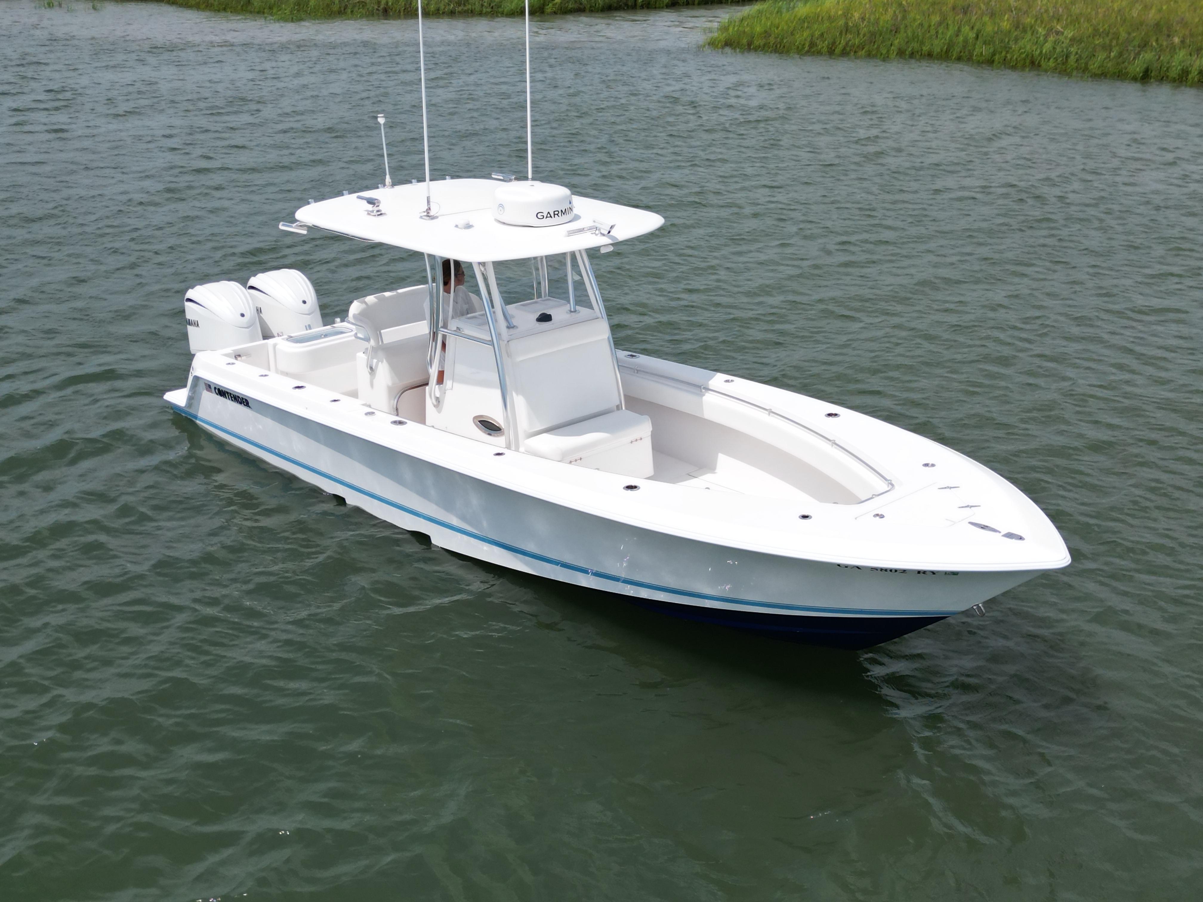 Contender 30 ST 2022 Contender 30 ST boat on water, featuring dual engines and sleek design.