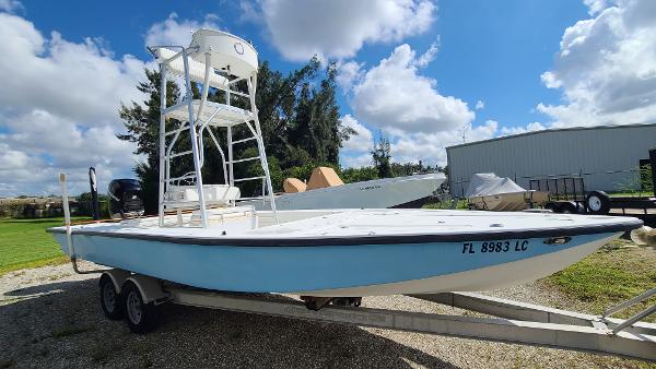Custom Shallow Draft 24 Bay Custom Shallow Draft 24 Bay boat on trailer, 2000 model, under a partly cloudy sky.