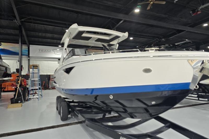 Cobalt A29 2026 Cobalt A29 boat on trailer in indoor showroom setting.