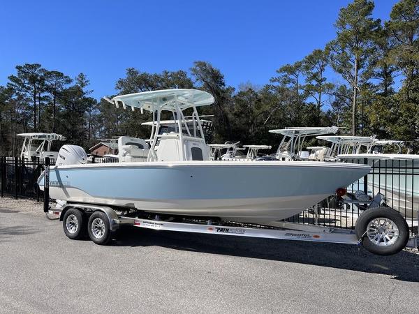 Pathfinder 2400 TRS 2025 Pathfinder 2400 TRS boat on trailer, parked outdoors with trees in background.