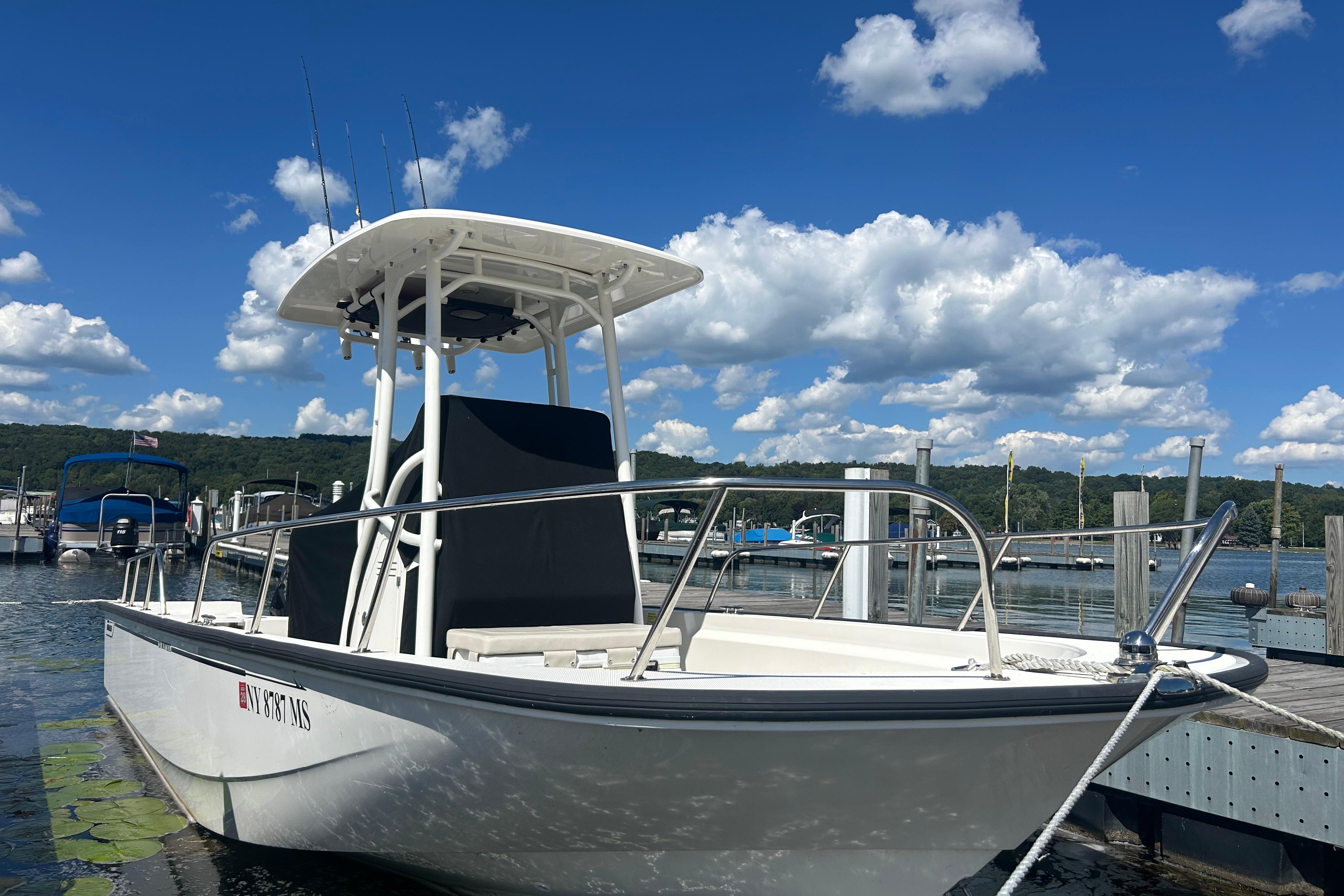 Boston Whaler 210 Montauk 2022 Boston Whaler 210 Montauk boat docked under a clear blue sky.