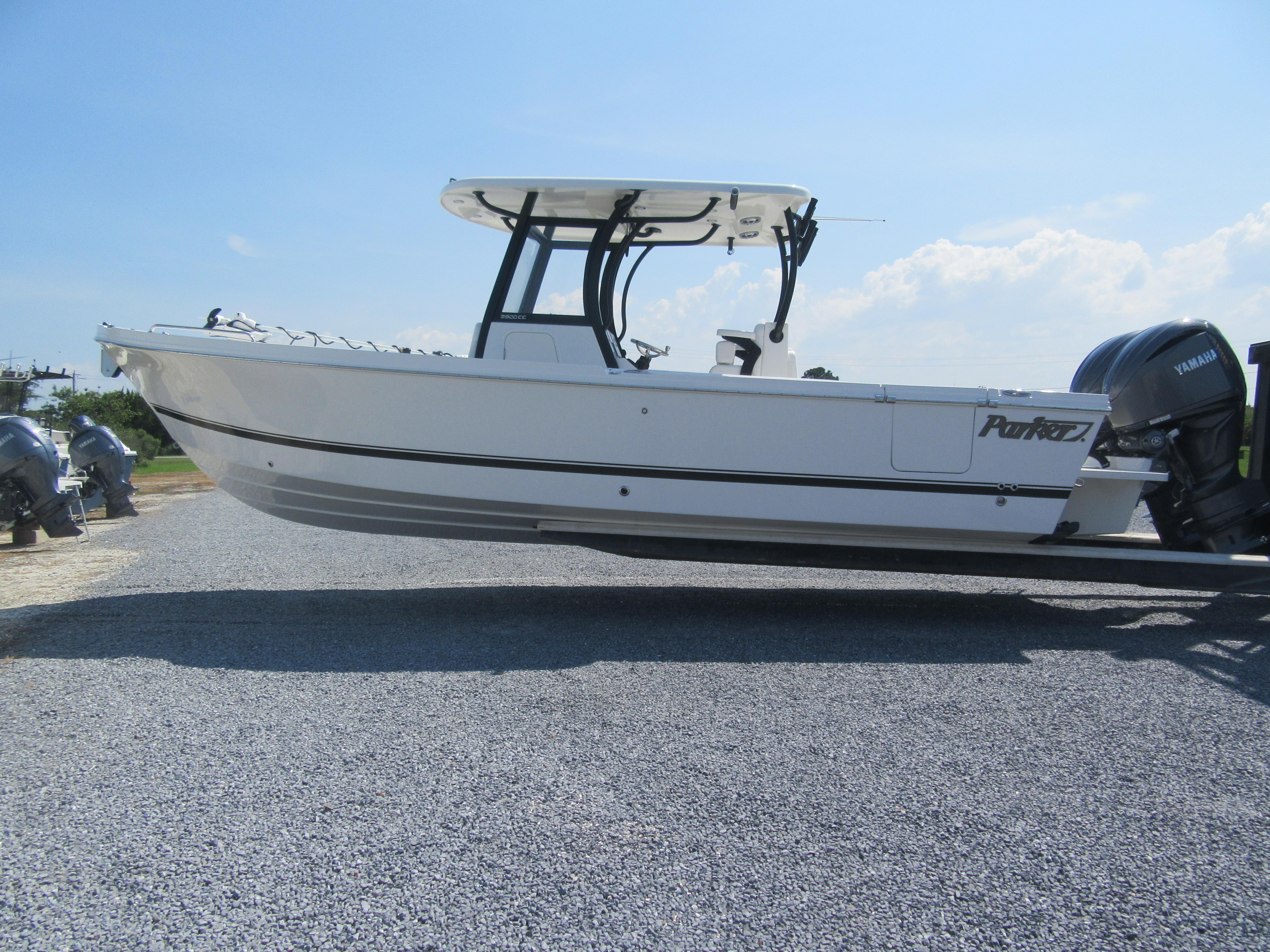 Parker 2900 Center Console 2025 Parker 2900 Center Console boat on gravel, featuring Yamaha engines, under clear blue sky.