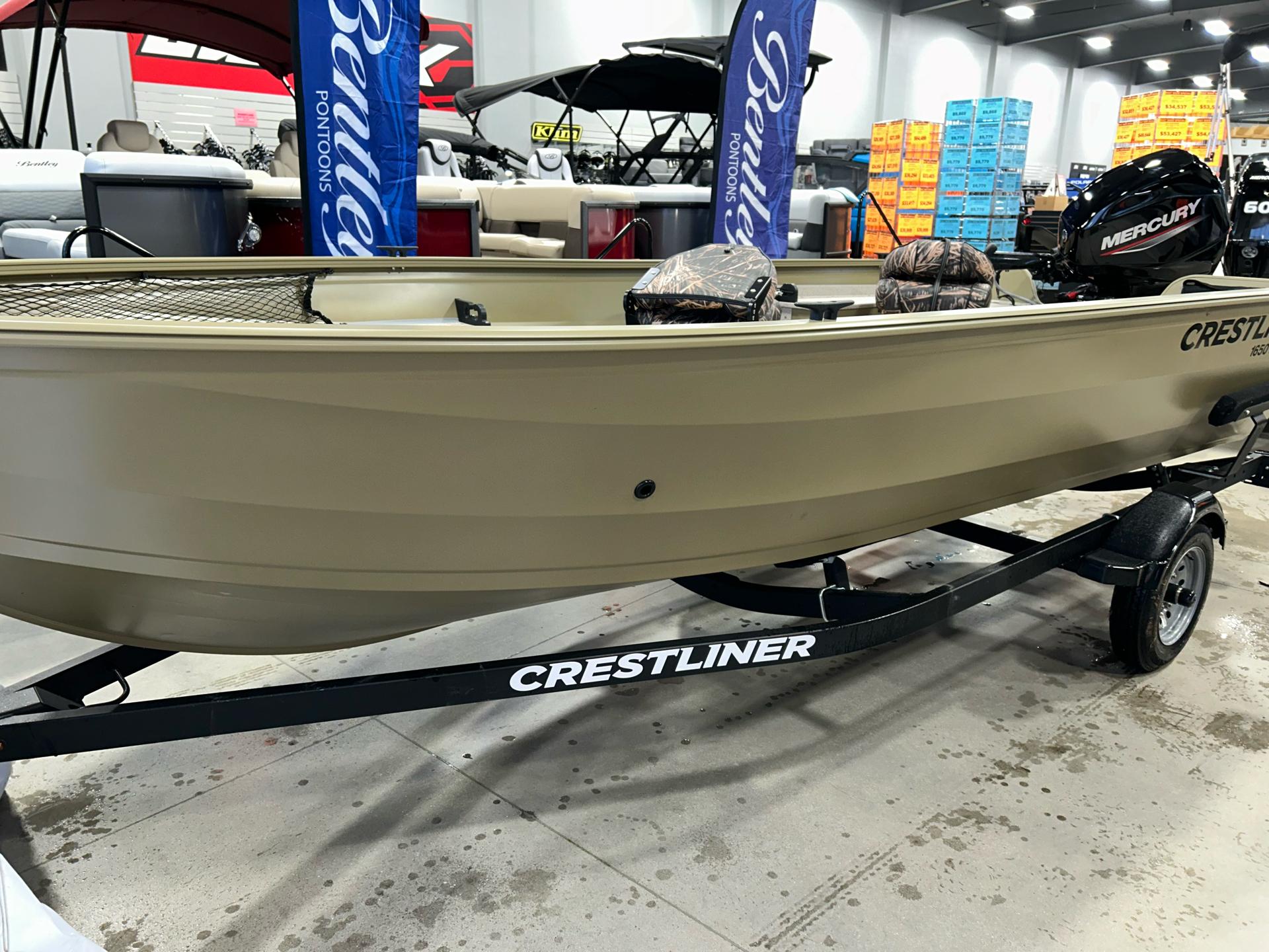 Crestliner 1650 Discovery Tiller 2023 Crestliner 1650 Discovery Tiller boat on display with Mercury engine.