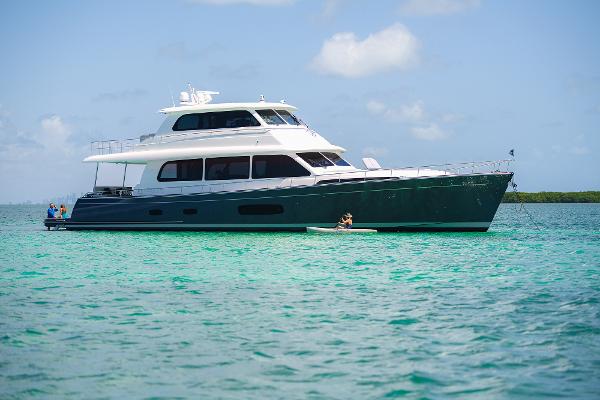 Grand Banks GB 85 2026 Grand Banks GB 85 yacht on turquoise water under blue sky.