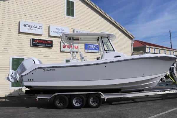 Edgewater 285CC 2023 Edgewater 285CC boat on a trailer outside a dealership.