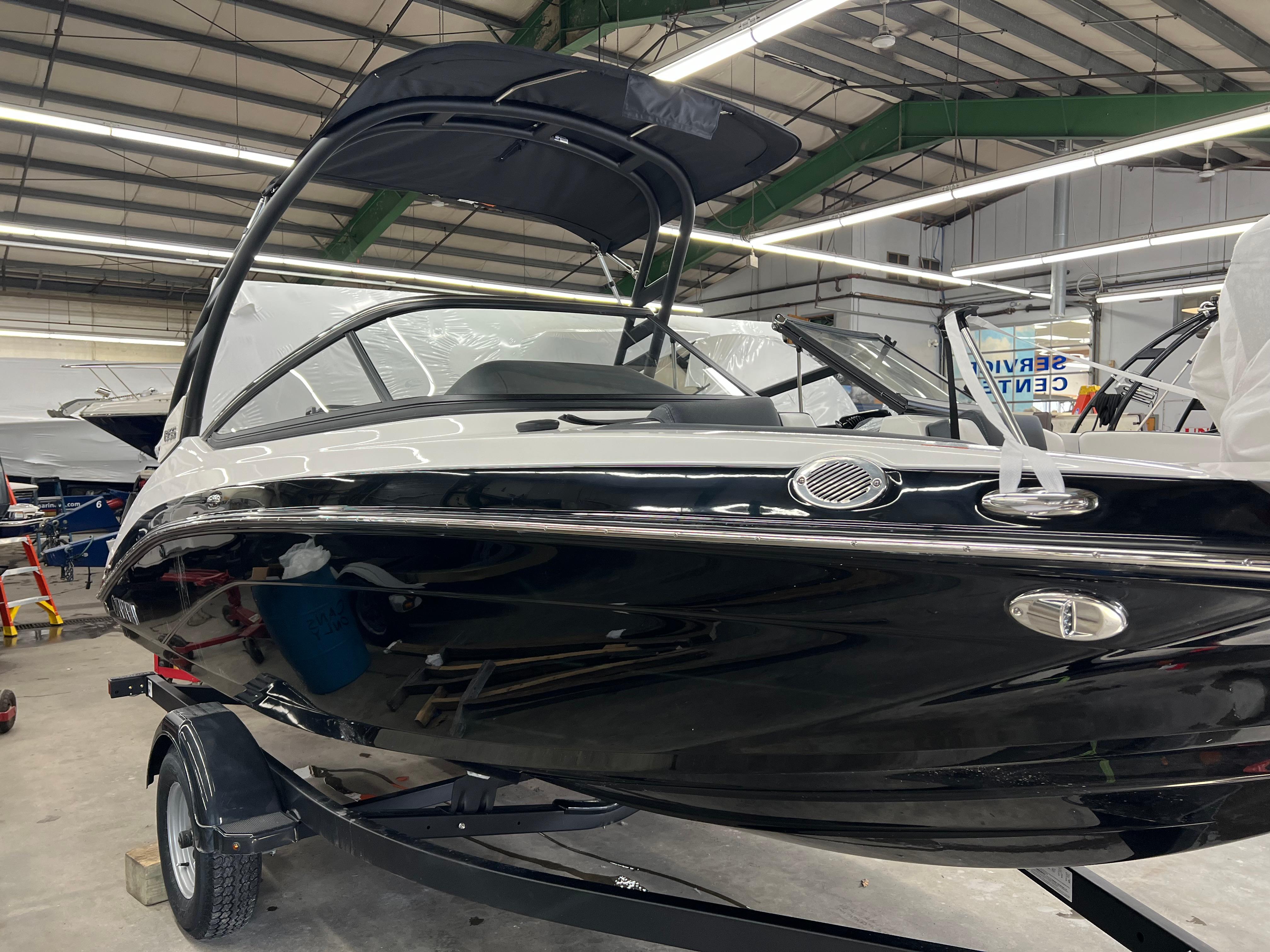 Yamaha Boats 195S 2024 Yamaha Boats 195S in showroom, sleek black and white design, on trailer.