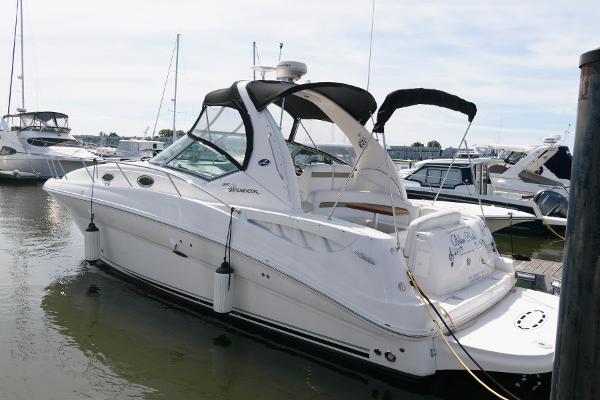 Sea Ray 320 Sundancer 2006 Sea Ray 320 Sundancer yacht docked at marina, featuring sleek design and canopy.