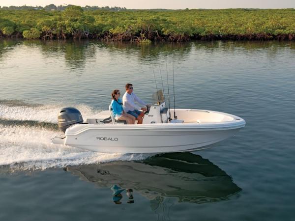 Robalo R160 2025 Robalo R160 boat cruising on calm water with two passengers.