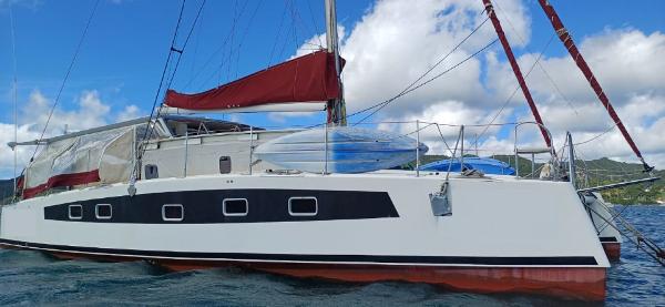 Catathai 44 Grand Voyage 2017 Catathai 44 Grand Voyage catamaran with red sails on a sunny day.