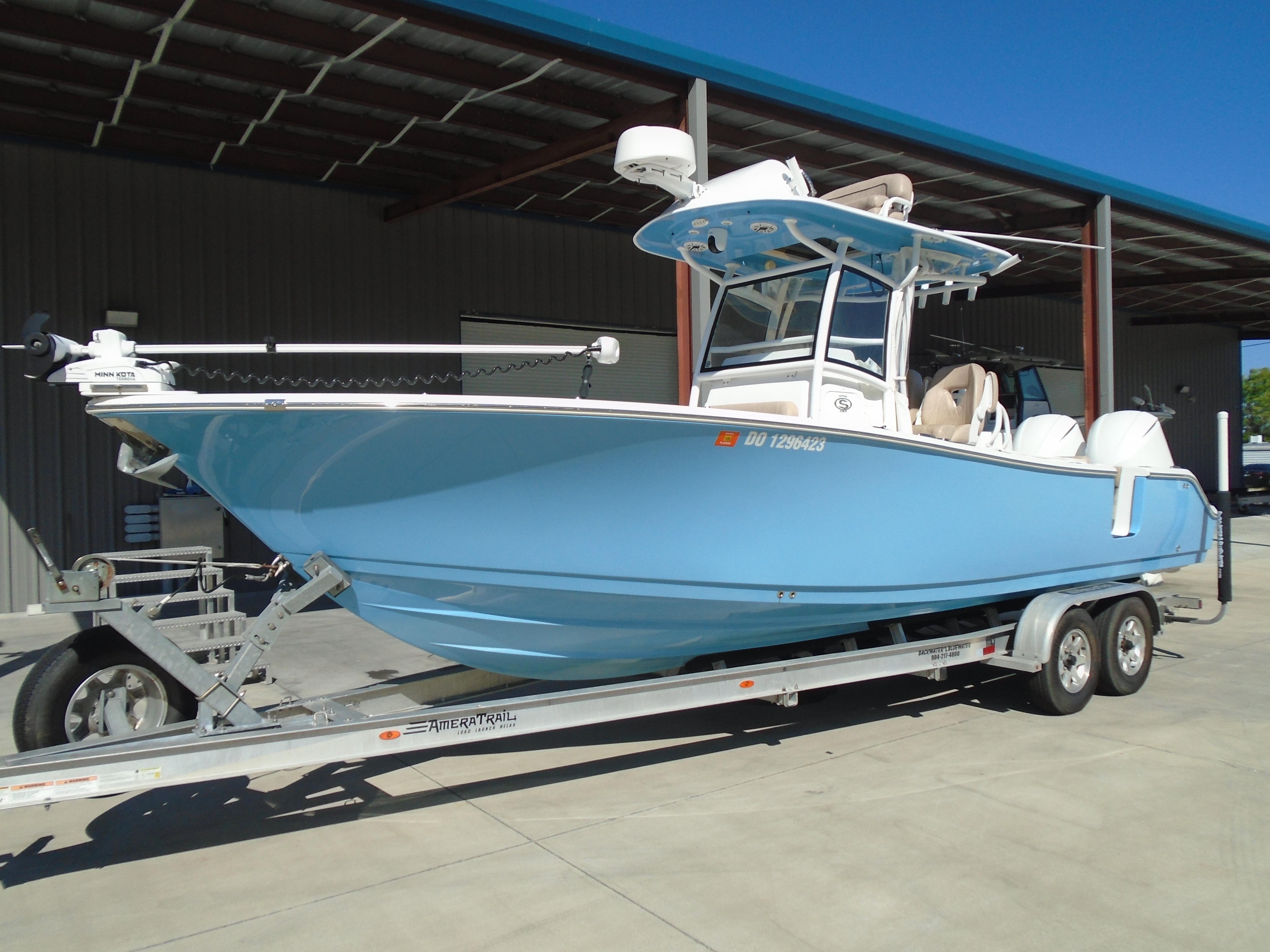 Sportsman Open 282TE Center Console 2019 Sportsman Open 282TE Center Console boat on trailer, light blue hull.