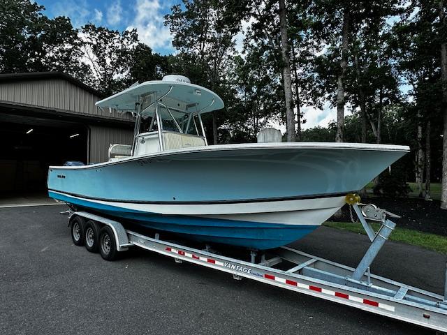 Regulator 29 Forward Seating 2008 Regulator 29 Forward Seating boat on trailer, parked outdoors near a garage.