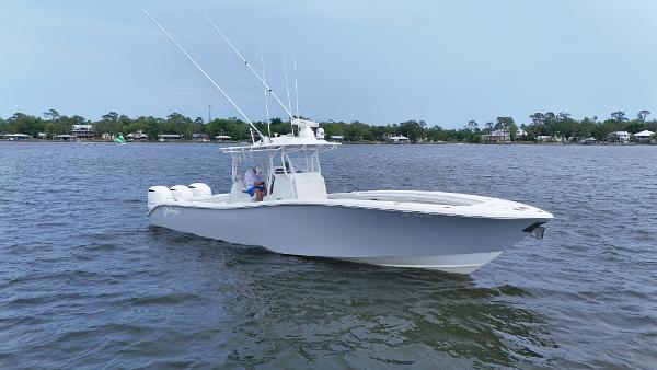Yellowfin 36 Offshore 2017 Yellowfin 36 Offshore boat on calm waters, featuring triple engines and fishing rods.