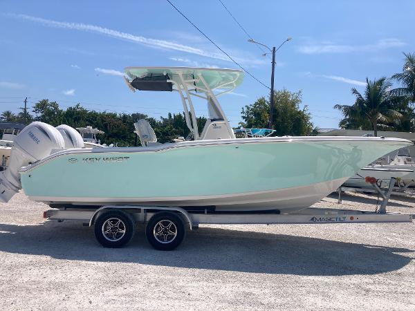 Key West 244 CC 2025 Key West 244CC boat on trailer, light blue hull, parked outdoors.