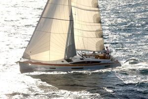 Jeanneau 53 Sailing yacht Jeanneau 53, 2011 model, gliding on sunlit ocean waters.