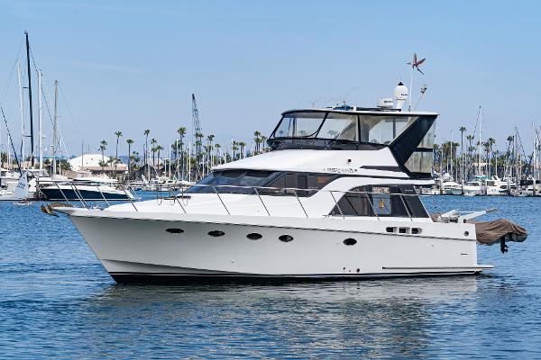 Ocean Alexander 420 Sport Sedan 1995 Ocean Alexander 420 Sport Sedan yacht on calm water, marina background.