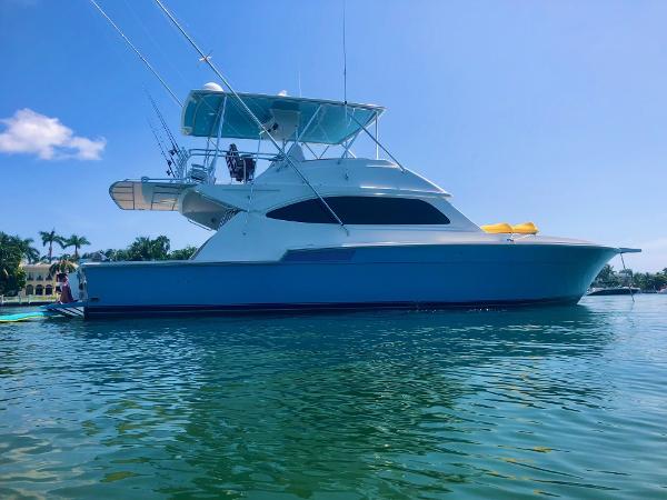 Bertram 54 Convertible 1989 Bertram 54 Convertible yacht on calm water under clear blue sky.