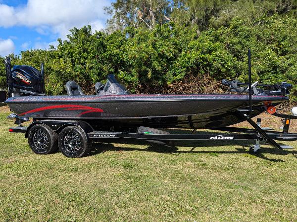 Falcon F20 PREDATOR 2025 Falcon F20 PREDATOR boat on trailer, parked on grass with trees in background.