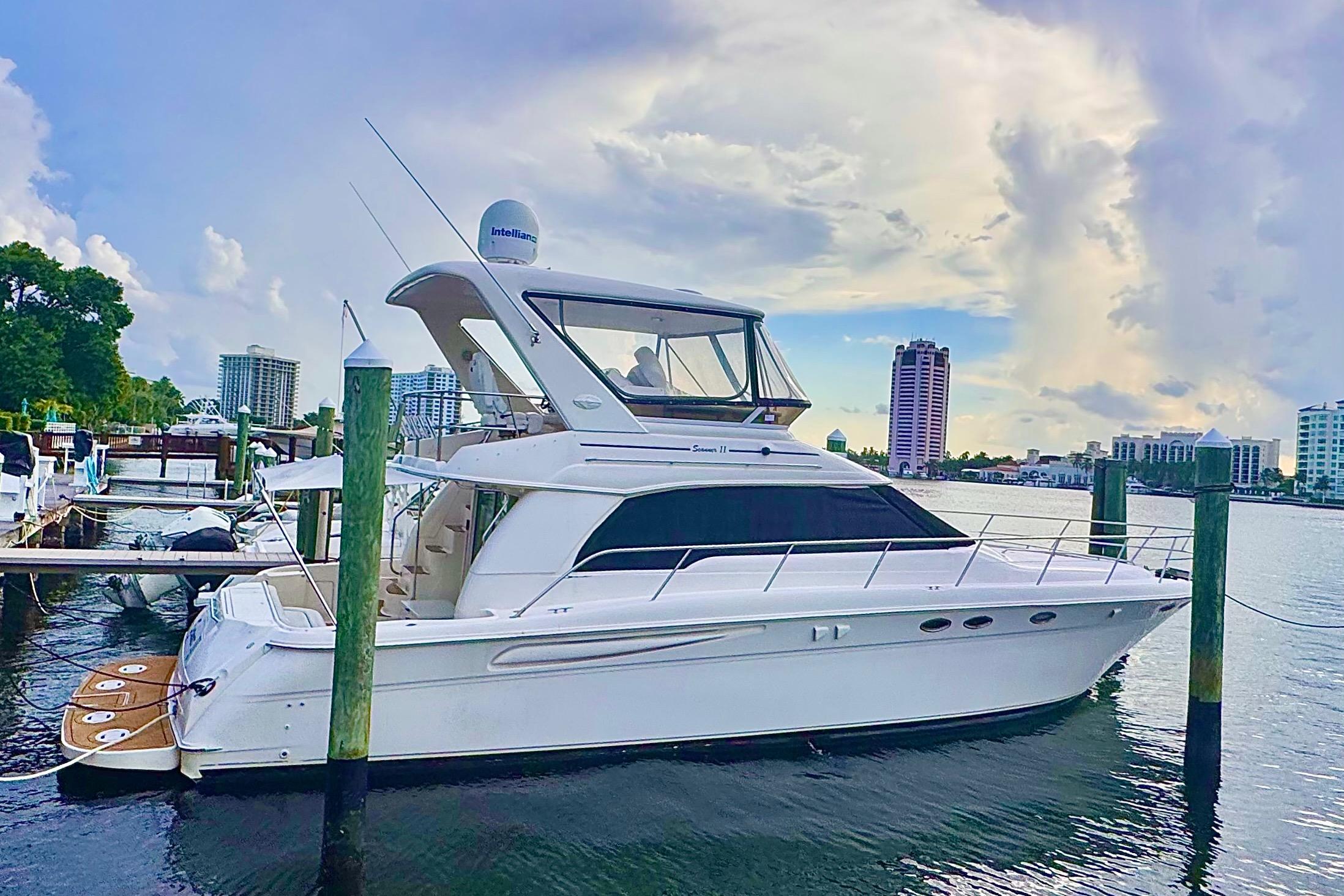 Sea Ray 480 Sedan Bridge 1998 Sea Ray 480 Sedan Bridge yacht docked in a marina with cityscape background.