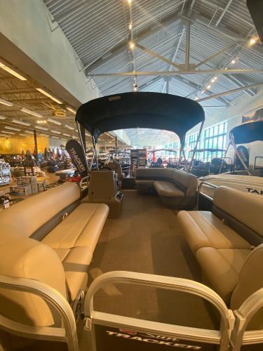 Sun Tracker Party Barge 16 DLX 2025 Sun Tracker Party Barge 16 DLX interior with spacious seating in showroom.