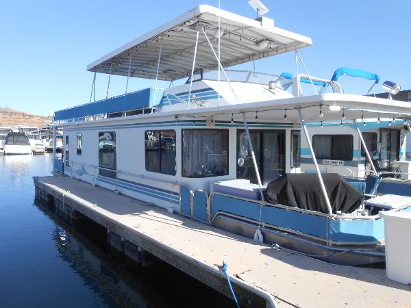 Stardust Cruisers Houseboat 2001 Stardust Cruisers houseboat docked at a marina on a sunny day.