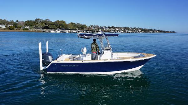 Sea Hunt Ultra 234 2015 Sea Hunt Ultra 234 boat cruising on a calm lake.