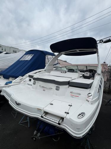 Chaparral 246 SSi 2019 Chaparral 246 SSi boat with sleek design, docked outdoors under cloudy skies.