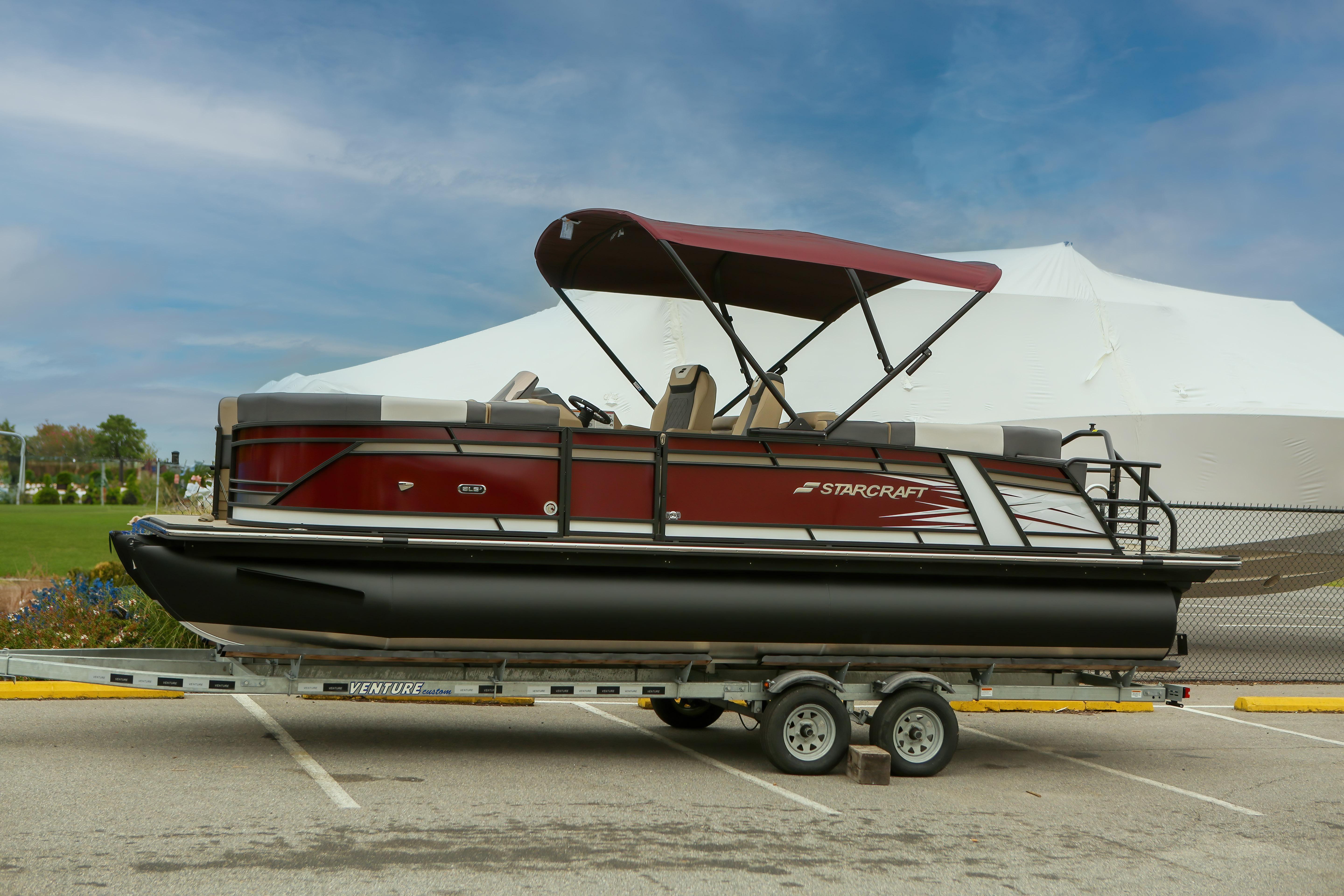 Starcraft SLS 3 R 2026 Starcraft SLS 3 R pontoon boat on trailer, featuring maroon canopy and sleek design.