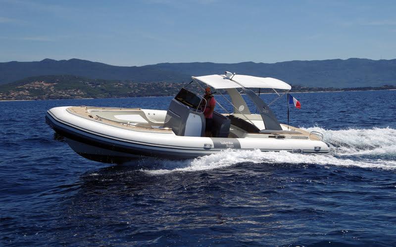 Wimbi Boats 9i 2017 Wimbi Boats 9i cruising on open water with scenic mountain backdrop.