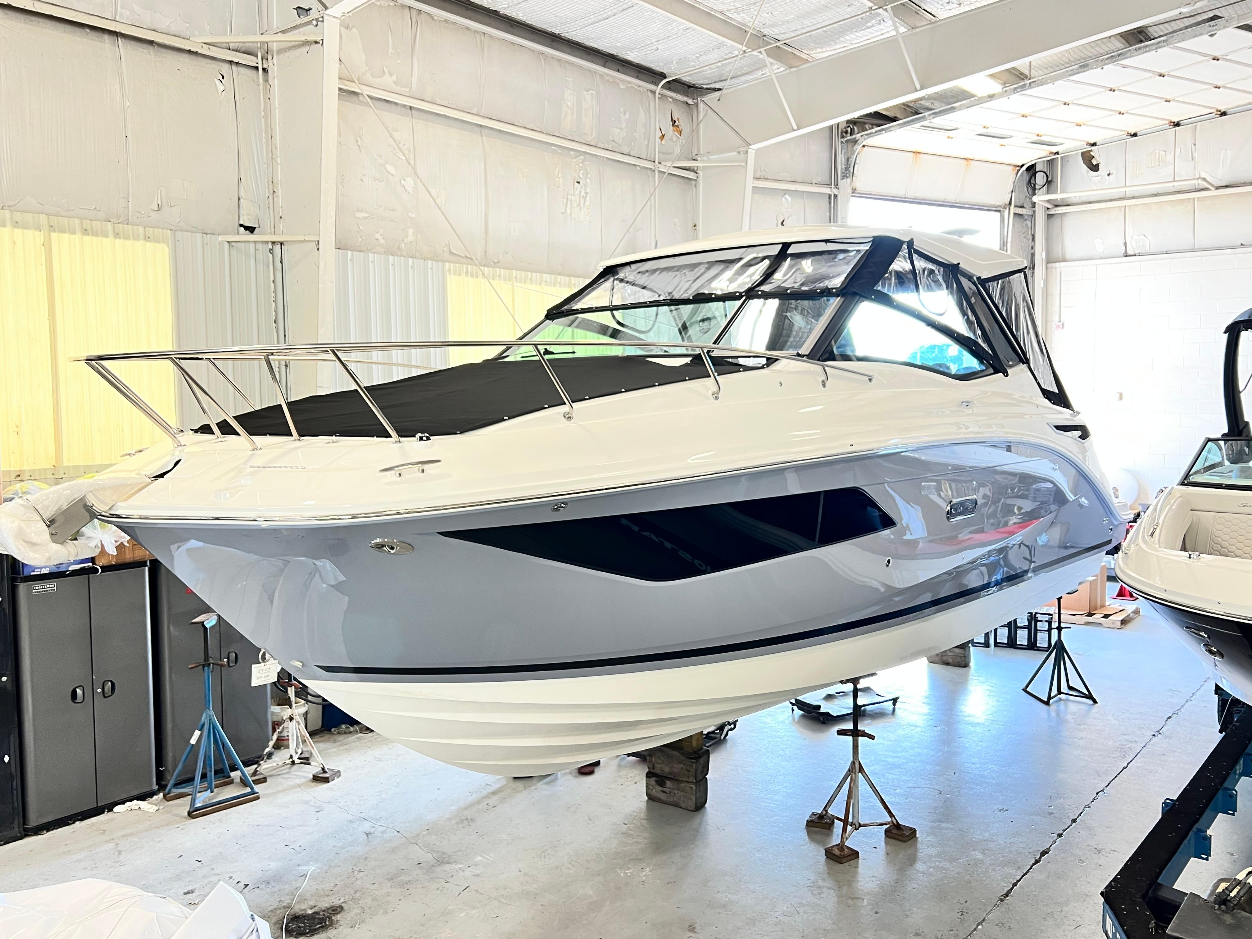 Sea Ray 320 Sundancer 2025 Sea Ray Sundancer 320 yacht in a boatyard, showcasing sleek design and modern features.