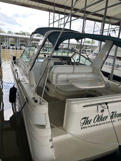 Sea Ray 290 Sundancer 1996 Sea Ray 290 Sundancer boat docked in marina, featuring spacious seating and canopy.
