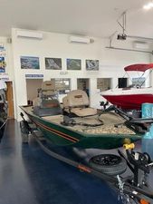 Tracker Bass Tracker Classic XL 2025 Tracker BT CLASSIC SE boat displayed in showroom with fishing seats and trailer.
