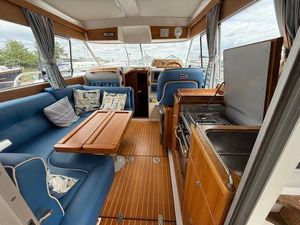 Nimbus 320 Coupe Interior of 2003 Nimbus 320 Coupe boat with blue seating and wooden accents.