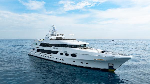 Christensen Tri-Deck Luxurious 2016 Christensen Tri-Deck yacht cruising on open sea under a partly cloudy sky.