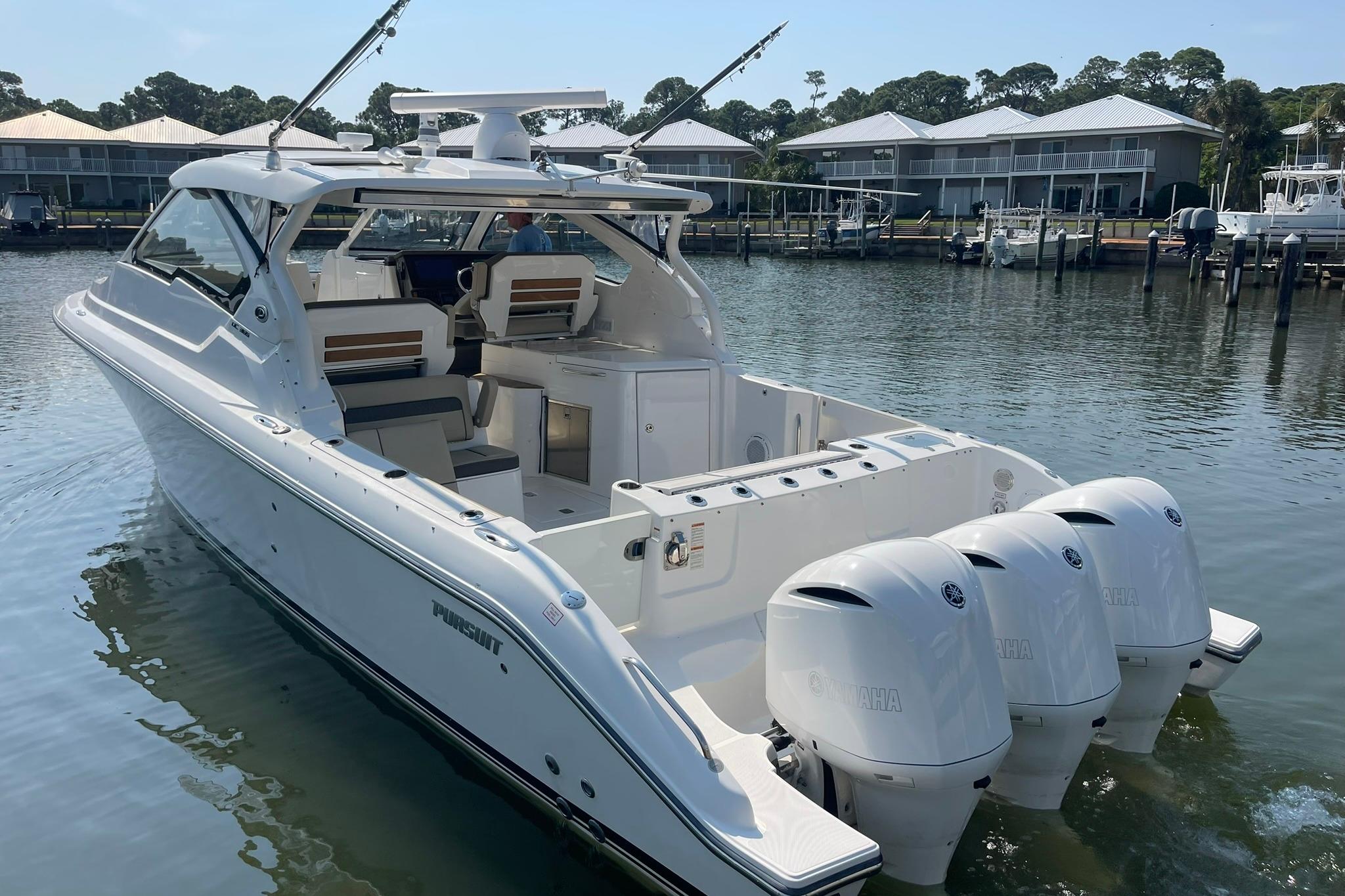 Pursuit DC 365 Dual Console 2018 Pursuit DC 365 Dual Console boat with triple Yamaha engines docked in marina.