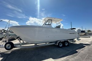 Twin Vee 260 GFX2 CC 2025 Twin Vee 260 GFX2 CC boat on trailer under clear sky.