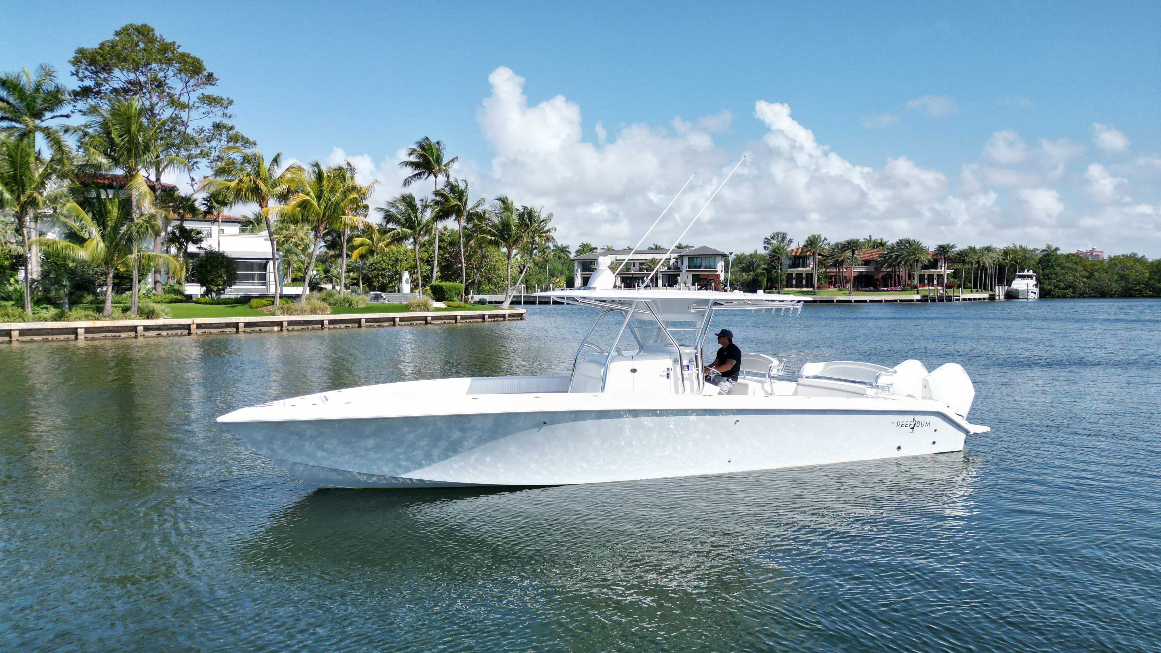 Bahama 35 Open 2023 Bahama 35 Open boat cruising on a scenic waterway with palm trees.