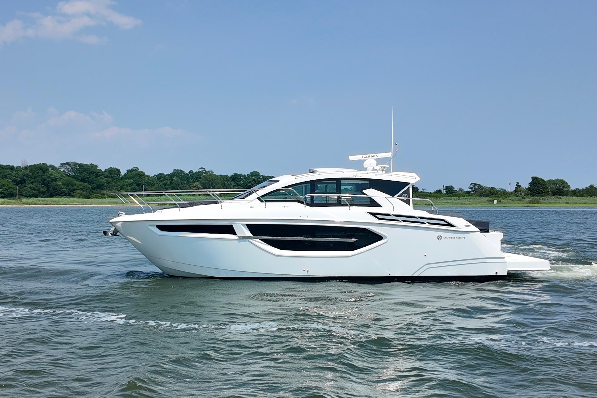 Cruisers Yachts 42 Cantius 2024 Cruisers Yachts 42 Cantius cruising on a sunny day, side view.